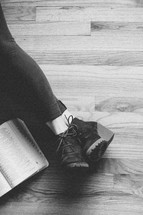 legs stretched out reading a Bible 