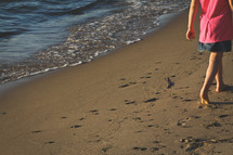 a girl walking on a beach 