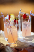 straws in glasses of strawberry lemonade