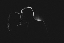 The silhouette of a man and woman dancing