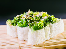 Sushi with Green Seaweed Chukka and Omelet Isolated on Black. Susi background. High quality photo