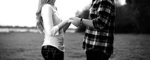 Young couple holding hands looking at each other