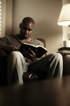 An African American man studying the Bible