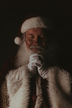 a praying Santa Claus 