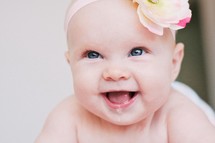 Smiling infant with bow