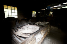 A primitive fire pit inside a warehouse