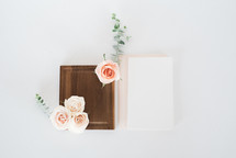pink roses, wooden tray and stationary 
