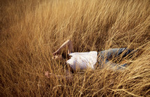 A woman lying in a field 
