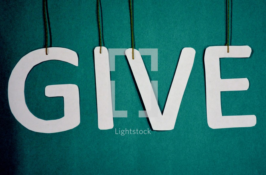 Letters spelling the word, "give," suspended from strings.