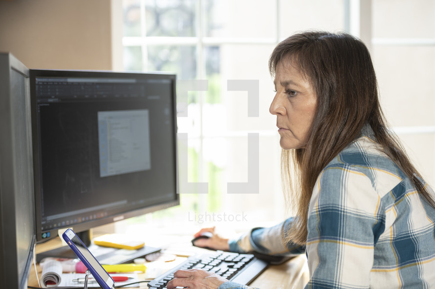 a woman sitting behind a computer 