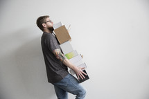 a man carrying a stack of boxes 