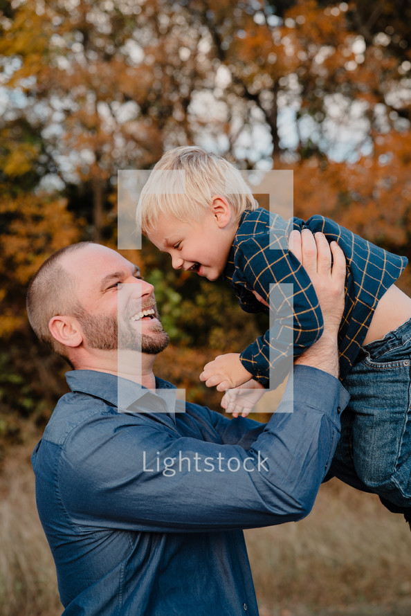 portrait of a loving father and son outdoors in fall 