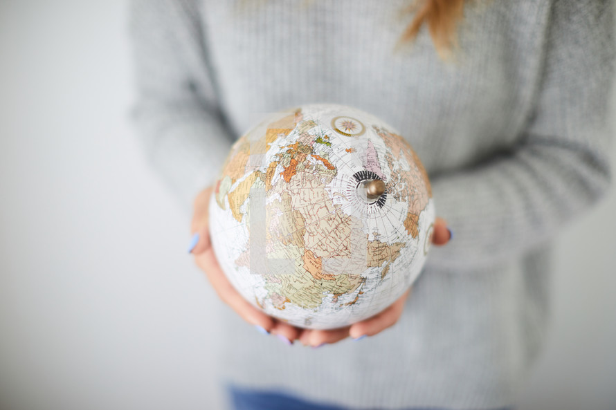 woman holding a globe 