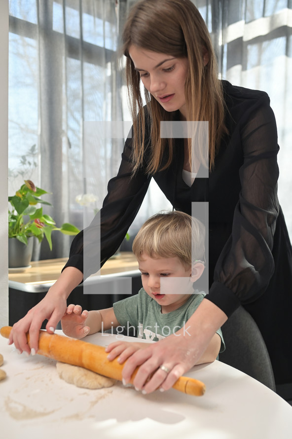 a mother and child baking in the kitchen 