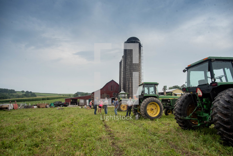 people and tractors on a farm 