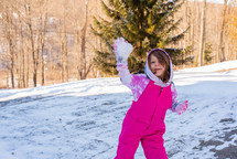 child throwing a snowball 