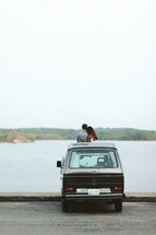 a couple standing with a VW van