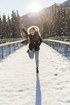 woman celebrating outdoors in snow 
