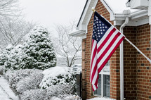 American flag on a house in the winter 