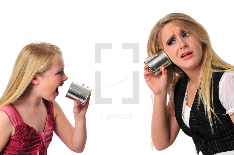 Mother and daughter talking on tin can phones.