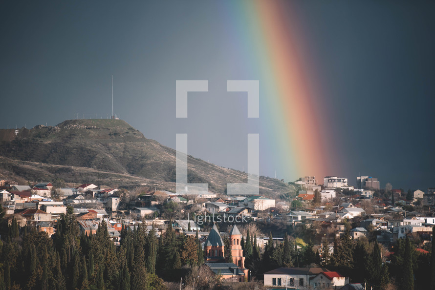 A rainbow in a sunny blue sky