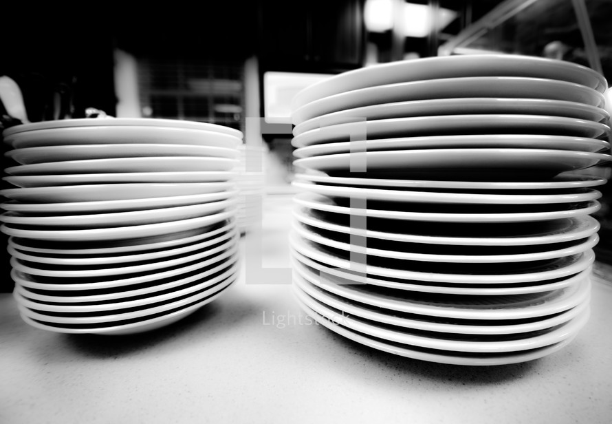 stacked white plates in a restaurant 