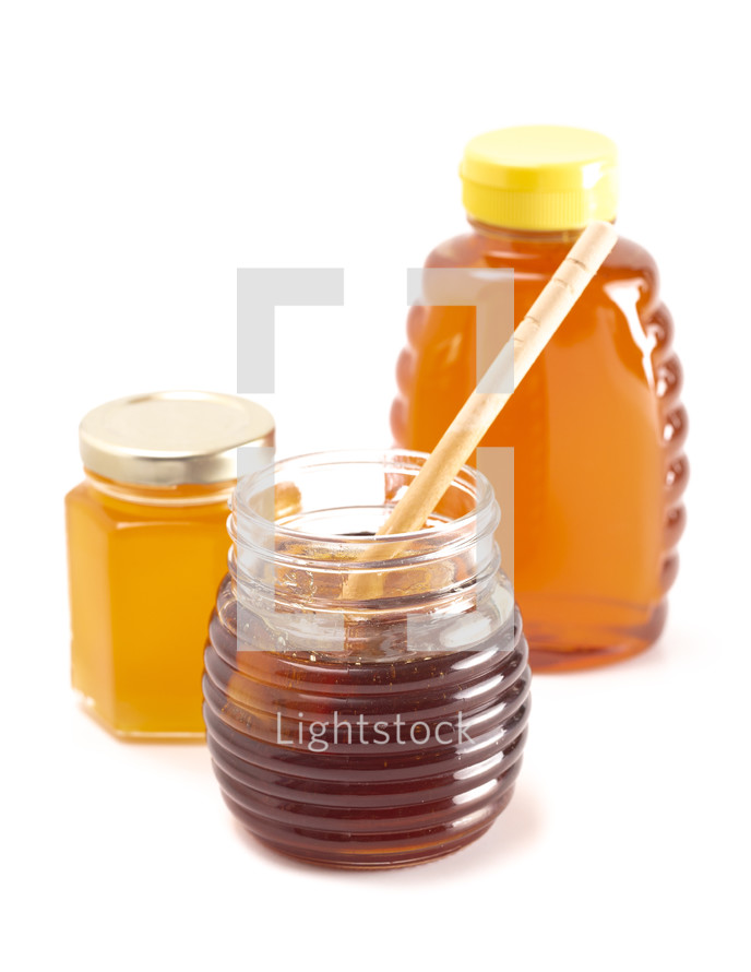 container of honey on a white background 