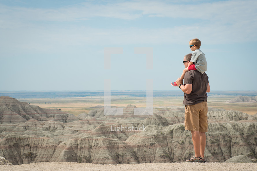 father and son looking out over a canyon