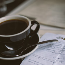A coffee cup and notes on a to do list 