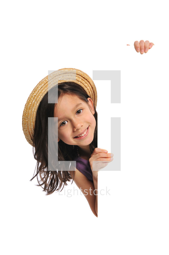 little girl in an Easter bonnet holding a sign 