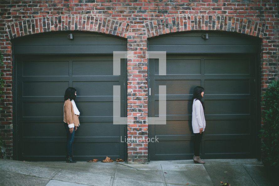 friends standing in front of doors 