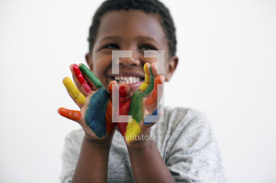 A little boy with painted hands 