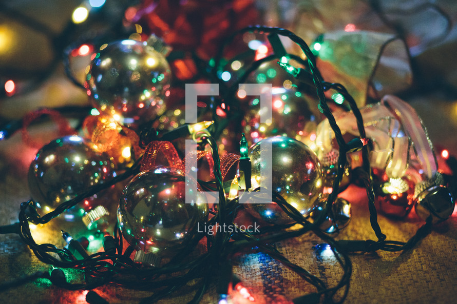 Christmas chaos - pile of ornaments, lights, and ribbon 