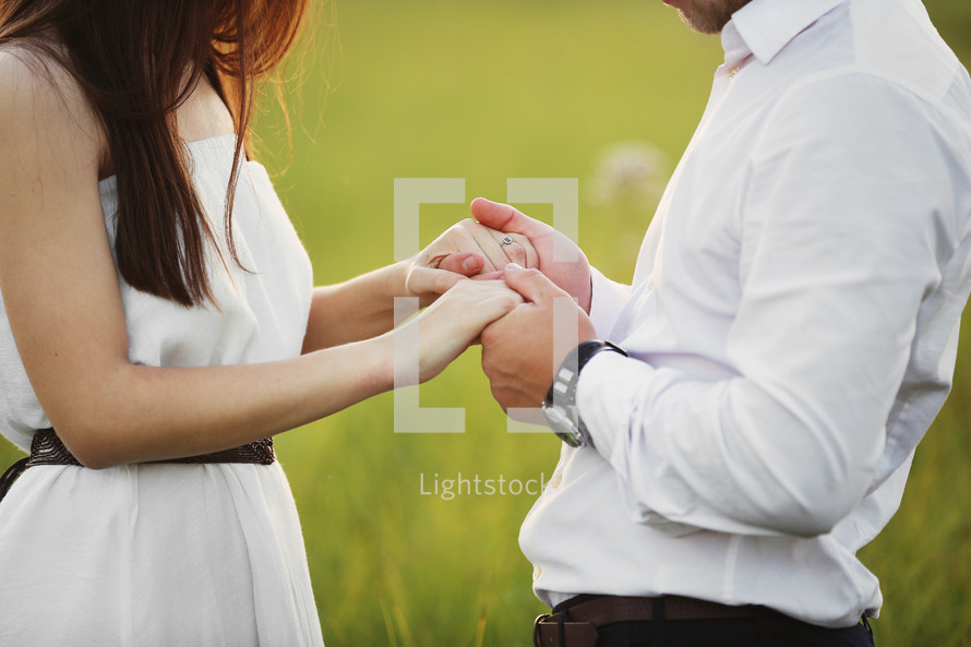 Hands together. Close-up of loving couple holding hands while walking outdoors. man friend husband support woman wife expressing love feelings, trust care honesty in relationship concept.