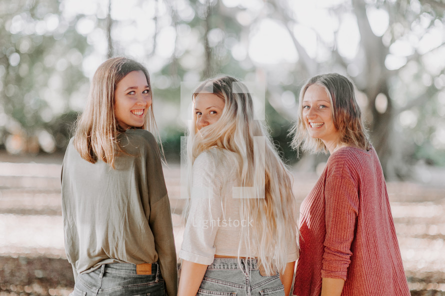 three women looking back at the camera 