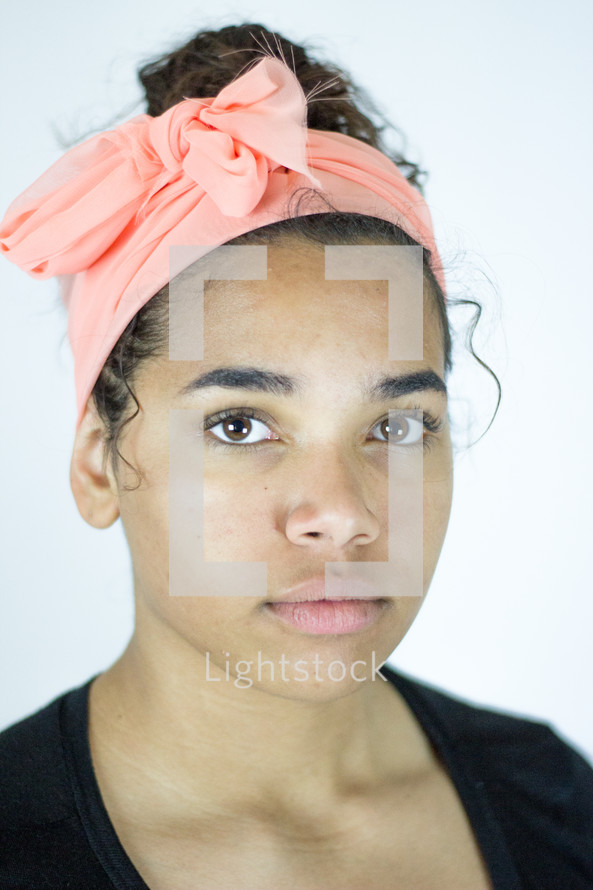 head shot of a young woman with a headband 