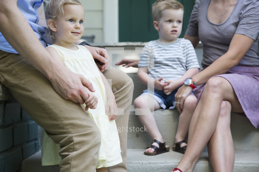 a family sitting on steps outdoors 