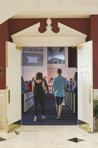 entering through doors into a church 