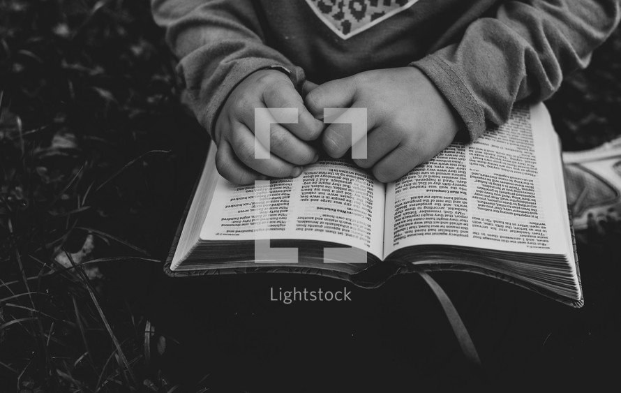a child with a Bible in her lap 