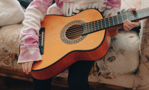 girl holding a guitar 