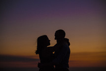 silhouette of a couple holding each other