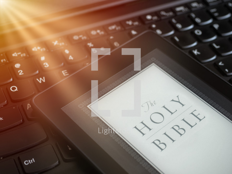 Close up of ebook reader with Bible 