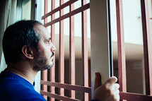man leaning out the window in the coronavirus quarantine