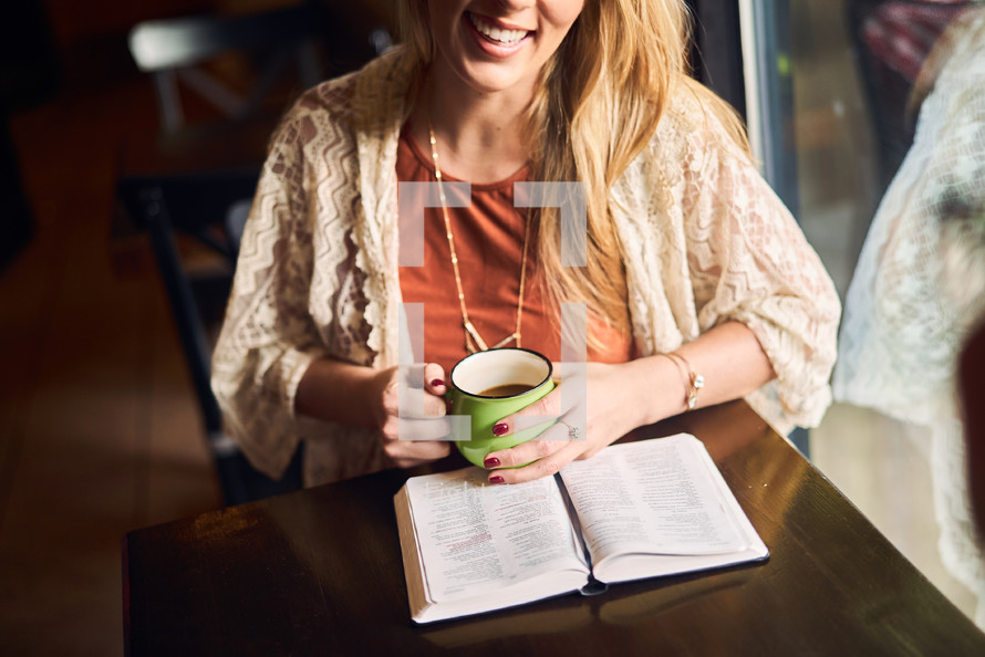women reading and discussing scripture over coffee