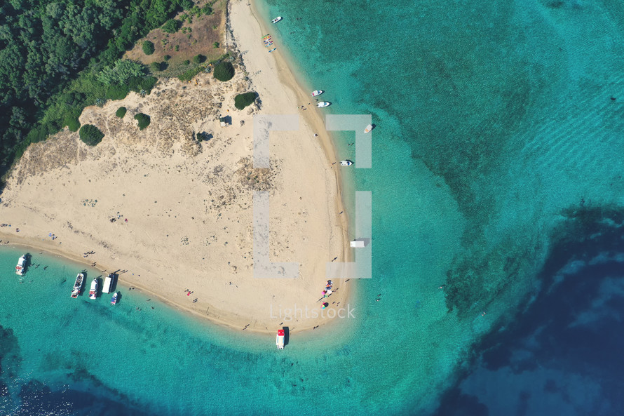Aerial drone view of iconic small uninhabited island of Marathonisi featuring clear water sandy shore and natural hatchery of Caretta-Caretta sea turtles, Zakynthos island, Ionian, Greece.