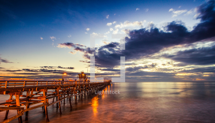 pier over the ocean at sunset 