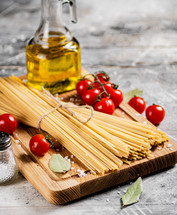 A pile of spaghetti dry on the table. Against a dark background. High quality photo