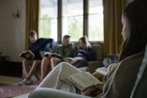 close up of young woman holding open her Bible in a small group study