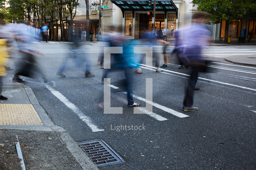 people walking across a crosswalk 