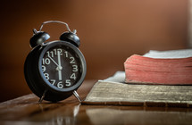 alarm clock and open Bible 
